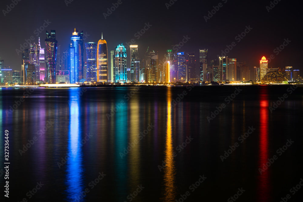 Fototapeta premium Vibrant Skyline of Doha at Night as seen from the opposite side of the capital city bay at night