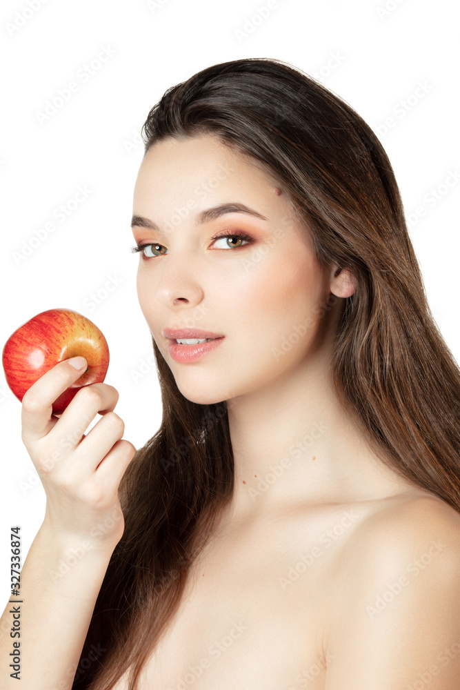 Portrait of an attractive young woman holding an apple in her hand Portrait of an attractive young woman holding an apple in her hand