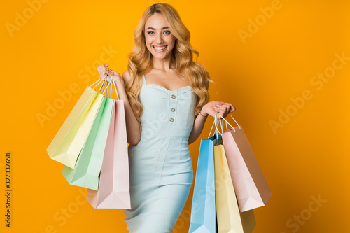 Sales concept. Pretty woman with colourful shopping bags