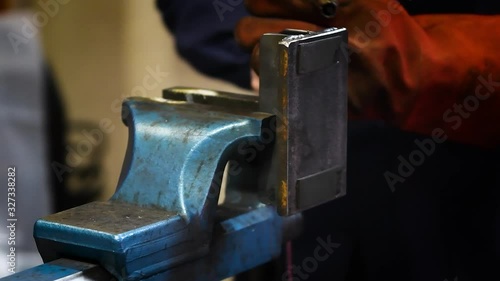 skilled welder worker while working in metalworking workshop