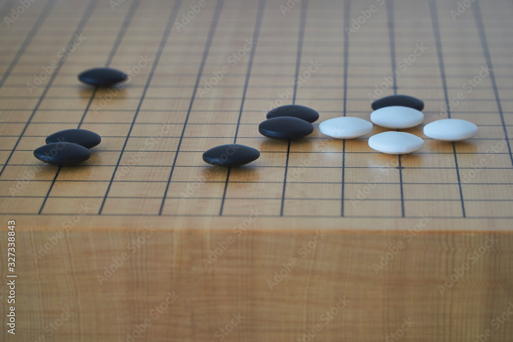 Closeup of some go stones with blurred edge of go board Closeup of some go stones with blurred edge of go board