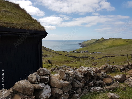 Grassroof house ocean stone wall faroe islands mykines