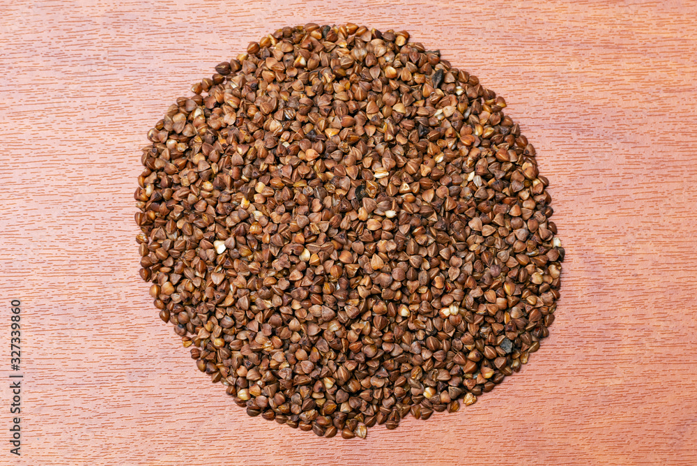 raw buckwheat on a wooden background raw buckwheat on a wooden background