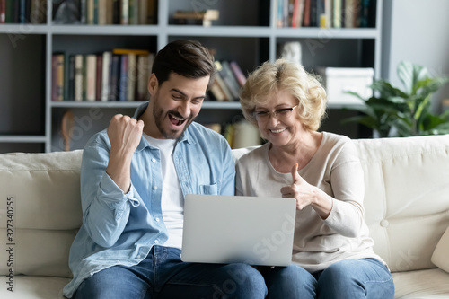 Overjoyed young man and senior mom relax at home together