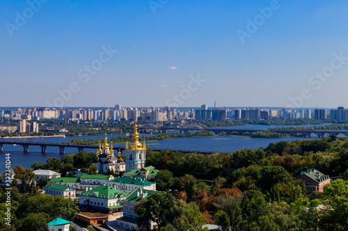 View of Kiev Pechersk Lavra (Kiev Monastery of the Caves) and the Dnieper river in Ukraine. View from Great Lavra Bell Tower © olyasolodenko