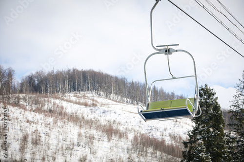 Empty chairlift at mountain ski resort. Winter vacation