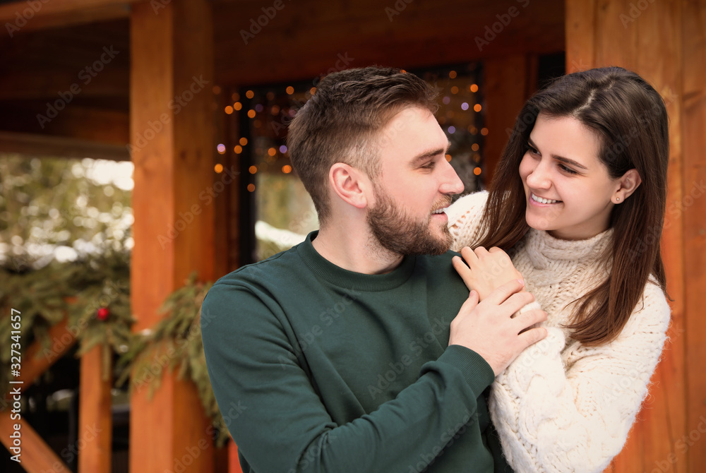 Happy couple in warm clothes outdoors. Winter vacation Happy couple in warm clothes outdoors. Winter vacation