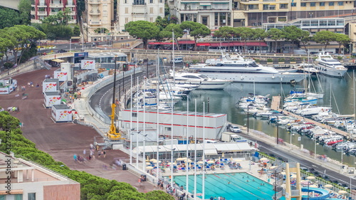 Seaside swimming pool in Monaco timelapse, with people and buildings in the background.