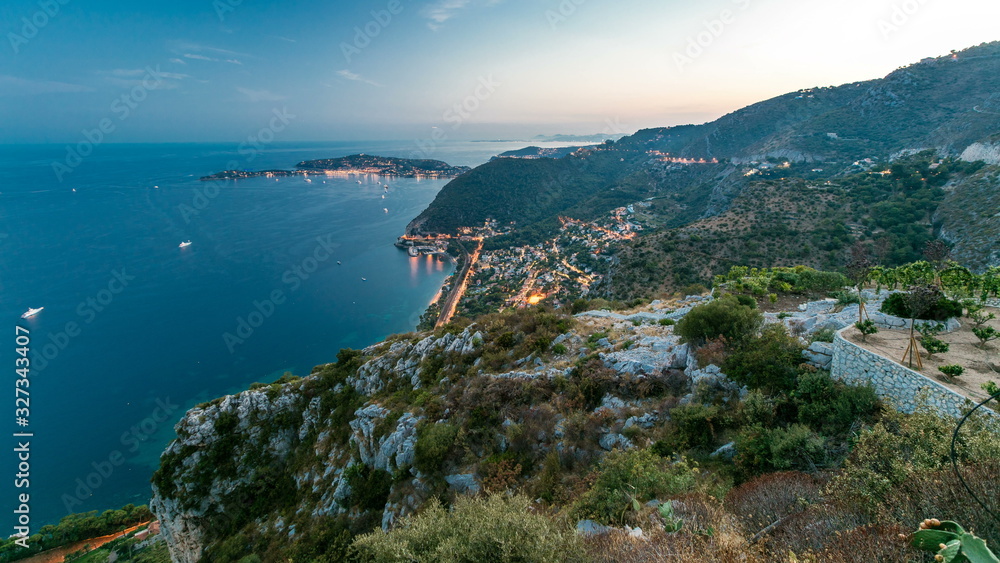 Day to night timelapse view of the Mediterranean coastline of the town of Eze village on the French Riviera