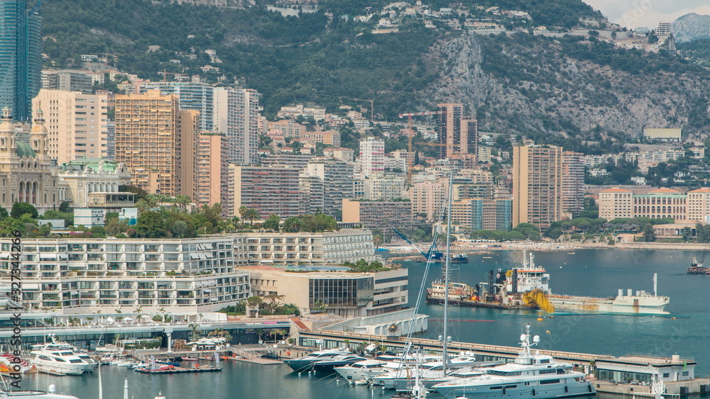Naklejka premium Monte Carlo city aerial panorama timelapse. View of luxury yachts and buildings in harbor of Monaco, Cote d'Azur.
