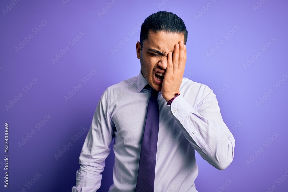 Young brazilian businessman wearing elegant tie standing over isolated purple background Yawning tired covering half face, eye and mouth with hand. Face hurts in pain. Young brazilian businessman wearing elegant tie standing over isolated purple background Yawning tired covering half face, eye and mouth with hand. Face hurts in pain.
