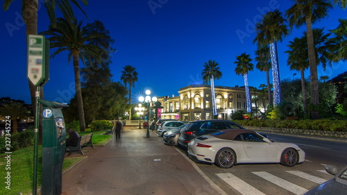 Night view to street with palms on the center of Beaulieu-sur-Mer timelapse . © neiezhmakov