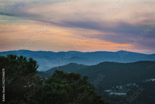 Mountain scenery. Beautiful sunset above the tops of the mountains. Sunset in the sky and mountains in the mist. 