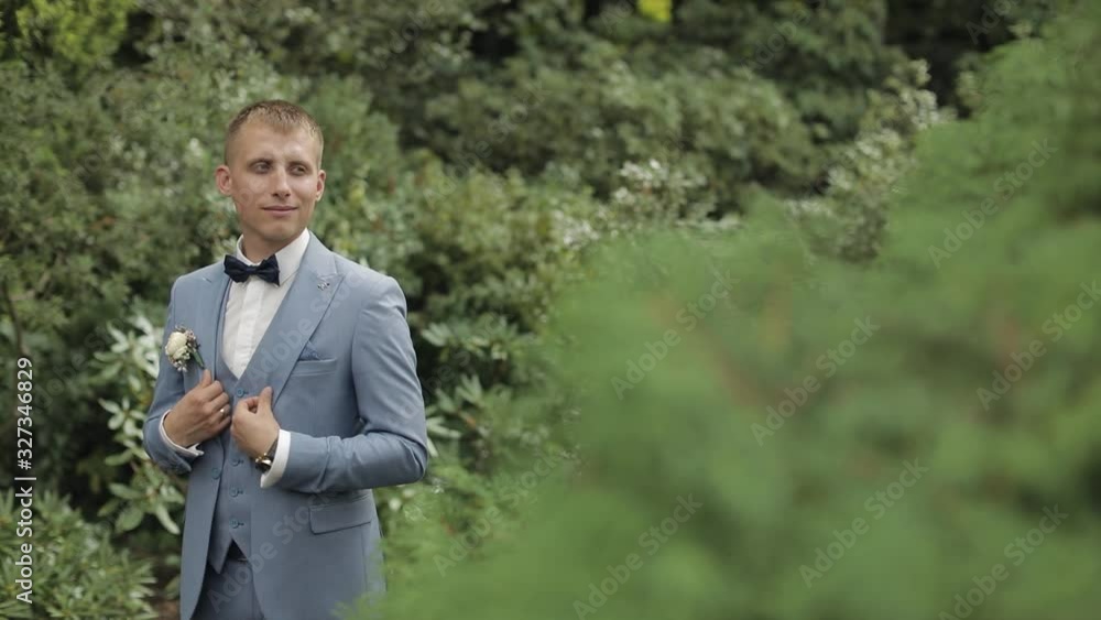 Groom, brunette young man in the park. Wedding day. Businessman Groom, brunette young man in the park. Wedding day. Businessman