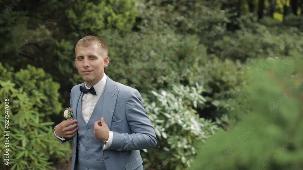 Groom, brunette young man in the park. Wedding day. Businessman Groom, brunette young man in the park. Wedding day. Businessman