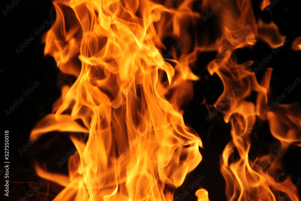 Blurred burning fire flame on the black background. Blurred burning fire flame on the black background.