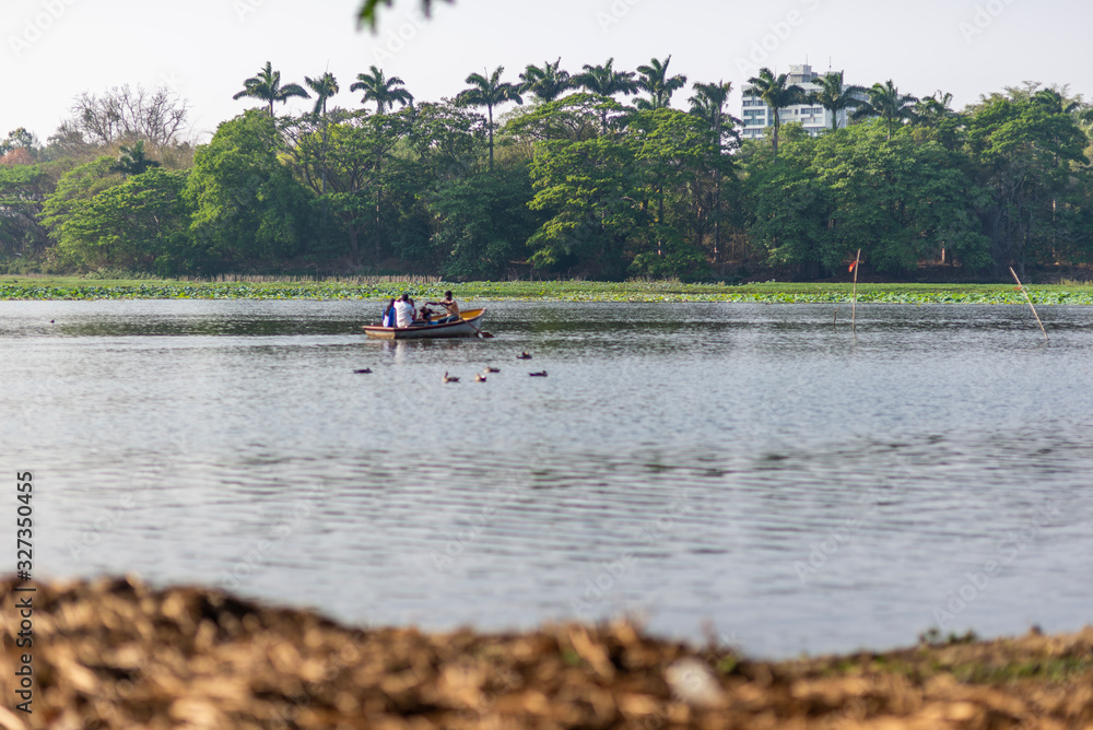 A group of unrecognisable four people is boating on Karanji Lake, Mysore, India