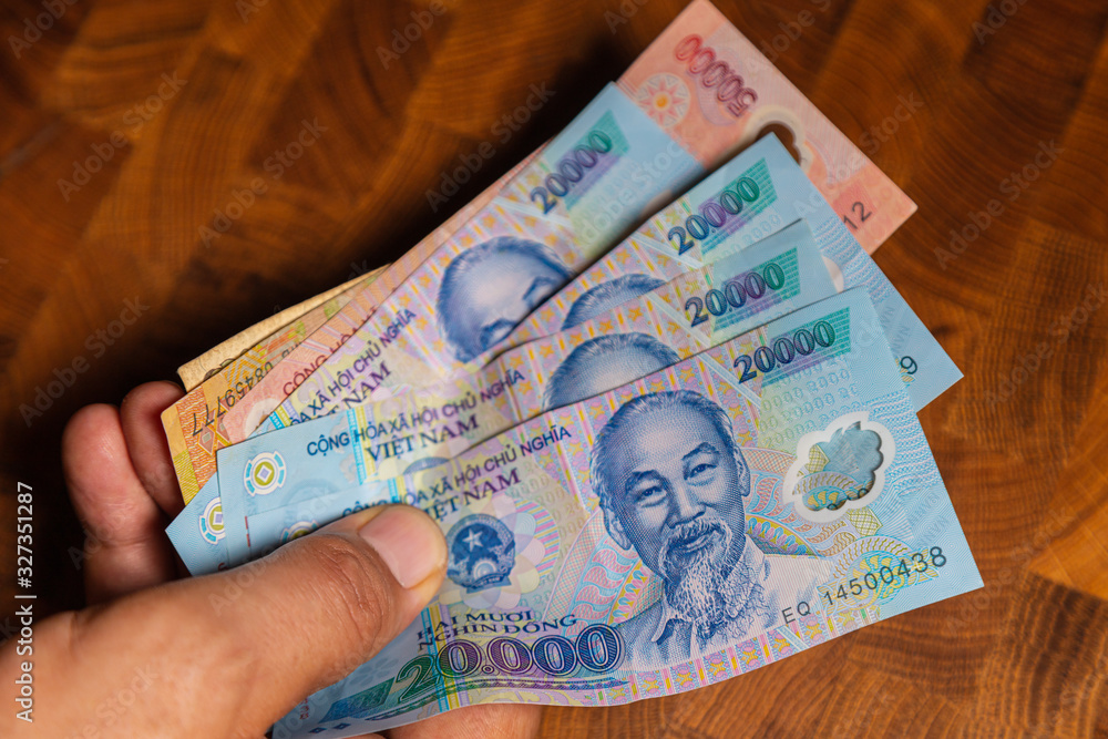 A Collection Of 20000 Vietnamese Dong Banknotes In A Male Hand Man 