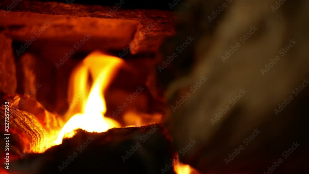 Smokehouse is a fire in oven and furnace made of beech and ash wood. Beautiful red flames smoke. Chamber of stoves made of stone and concrete, traditional folk buildings construction Smokehouse is a fire in oven and furnace made of beech and ash wood. Beautiful red flames smoke. Chamber of stoves made of stone and concrete, traditional folk buildings construction