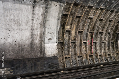 Old dirty wall in unused underground train tunnel  abstract grunge architecture background