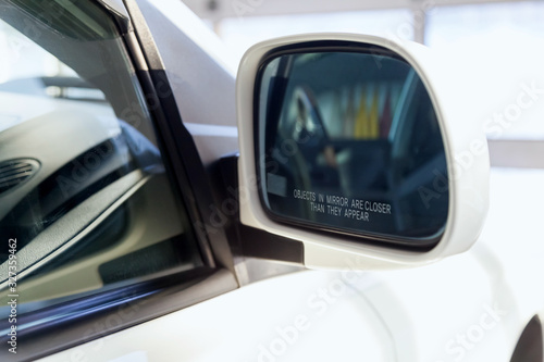 Side rear-view mirror with an inscription warning that objects are closer than cadets