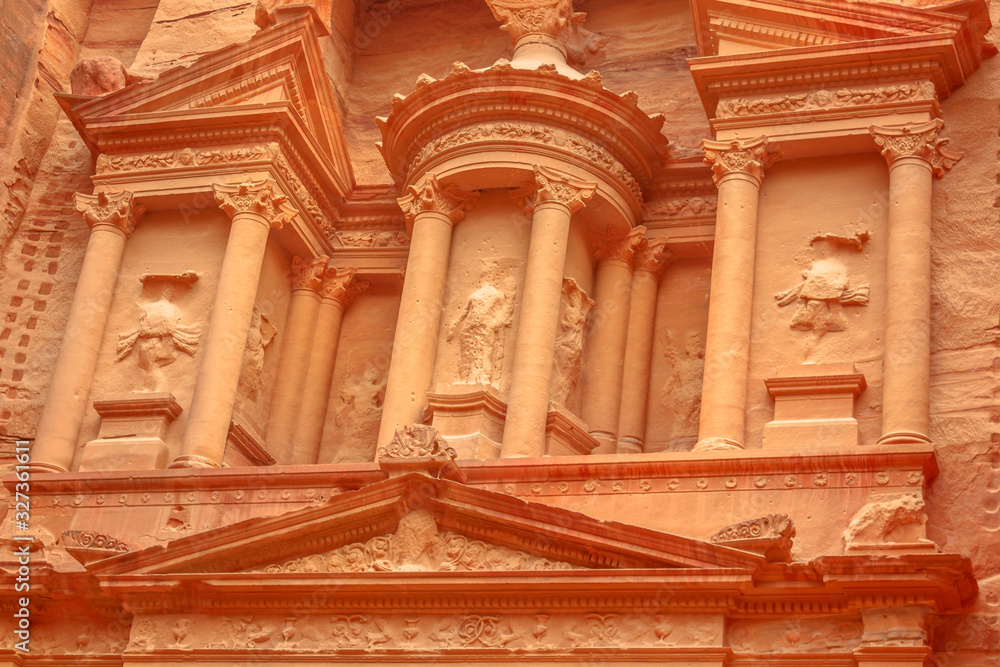 Architecture details of facade of The Treasury in Petra in Jordan. Archaeological heritage site and one of most popular tourist attractions carved out of a sandstone rock. Petra temple landmark.