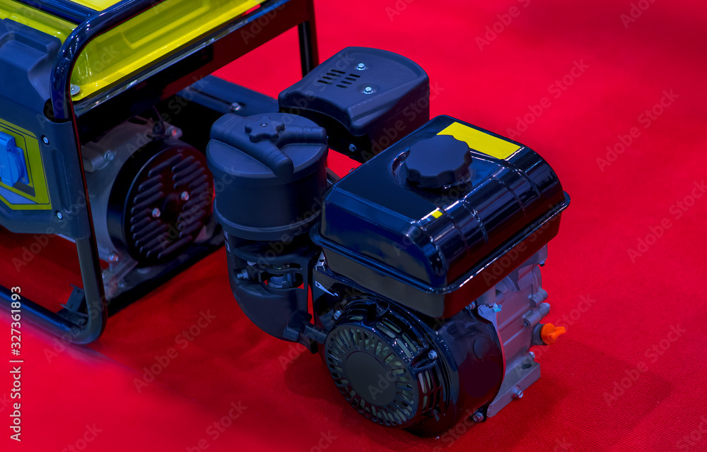Fototapeta premium Gasoline Portable Generator on the House Construction Site. Close up on Mobile Backup Generator .Standby Generator - Outdoor Power Equipment