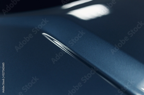 The car's paintwork. Abstract background in classic blue. Trend color. Close up. The texture of the paint