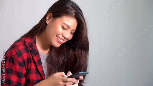 Beautiful asian woman chatting with boyfriend or friend on smartphone at foreign country by using internet online service. Pretty girl miss and love boyfriend. She feel happy when talking with family