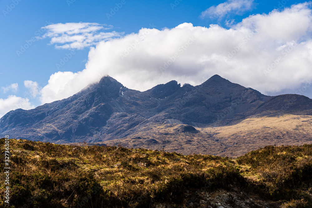 The Isle of Skye, connected to Scotland's north-west coast by a bridge, is characterised by its rugged landscape. This photo shows panoramic view on a funnel-shaped mountain.