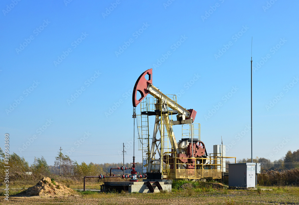 Oil drilling derricks at desert oilfield for fossil fuels output and crude oil production from the ground. Oil drill rig and pump jack.