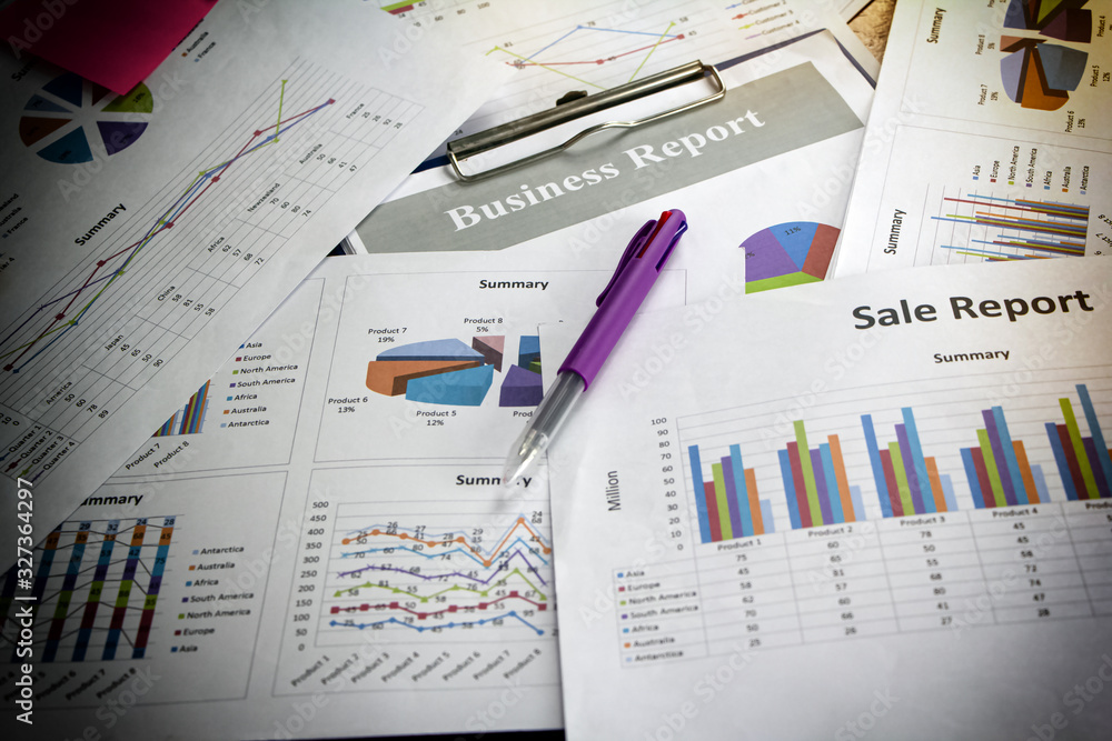 Obraz premium Business paper chart plenty on wooden desk,data for doing work.,blurry light around