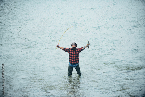 Brutal man stand in river water. Fishing hobby man in checkered shirt. Summer vacation. Life is always better when I am fishing. Relax in natural environment. Legend has retired. I am happiest man.