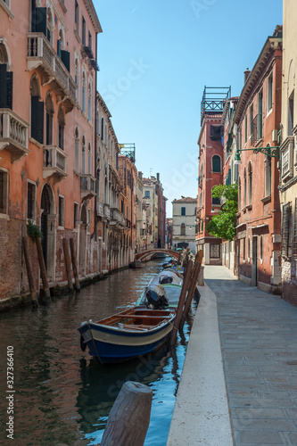 View of narrow Canal with boats and gondolas in Venice  Italy
