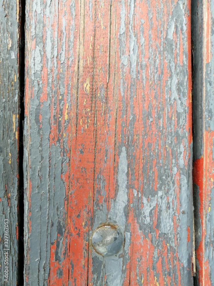 Beautiful background and texture of weathered wooden surface painted with old paint with vertical stripe and a circle below