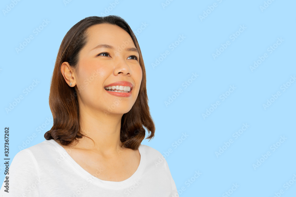 close up young beautiful asian woman smiling with dental aligner retainer tool (invisible) isolated on blue color background of dental clinic for beautiful teeth treatment course concept close up young beautiful asian woman smiling with dental aligner retainer tool (invisible) isolated on blue color background of dental clinic for beautiful teeth treatment course concept
