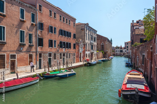 View of narrow Canal with boats and gondolas in Venice, Italy © k_samurkas