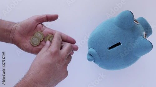 Saving mexican money on blue piggy bank