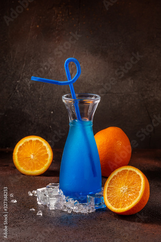 Delicious icy cocktail with fruits on dark grounge background. Healthy colorfull fruit shakes with ice on textured table. photo