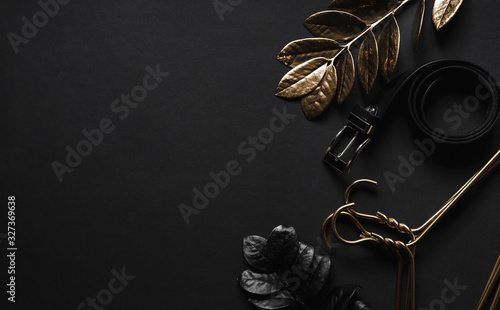 Fototapeta Objects luxury Flatlay on black background. Men accessories and beauty equipment and Luxury plants minimal. Top view with copy space. Minimalist black trendy 2020.