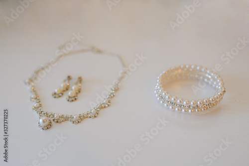Jewelry for the bride: necklace, earrings and bracelet with pearl beads. Selective focus