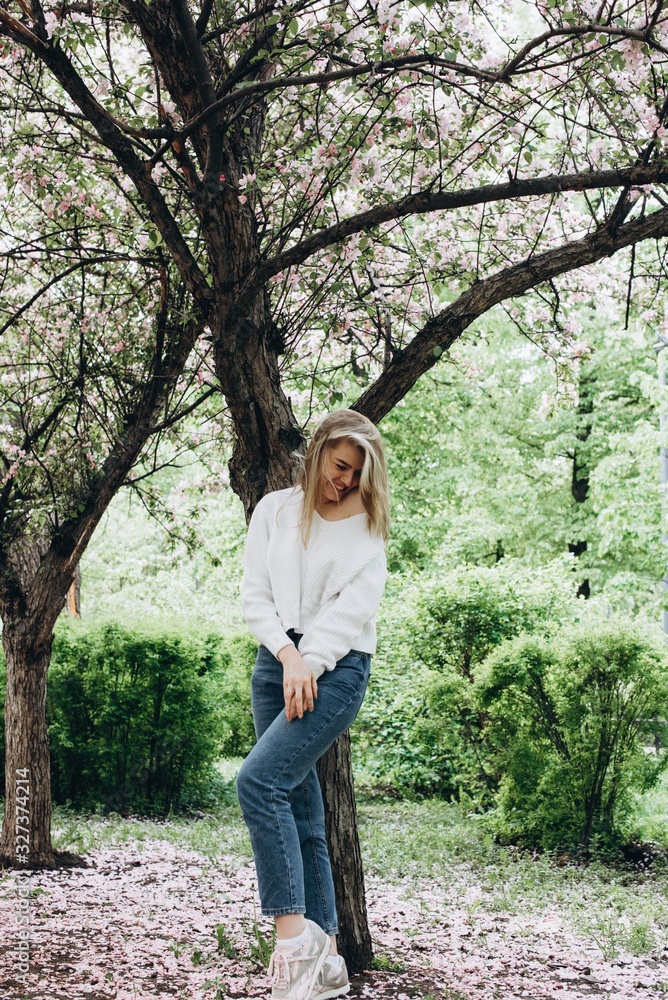 Portrait of a beautiful young woman looking at the park. Portrait of a smiling girl. Happy girl laughing in the park. Spring day. Summer vacation. Lifestyle. Portrait of a beautiful young woman looking at the park. Portrait of a smiling girl. Happy girl laughing in the park. Spring day. Summer vacation. Lifestyle.