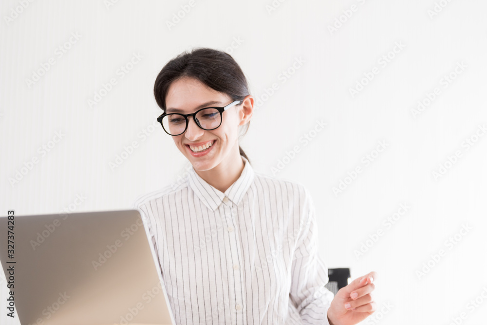 A businesswoman wearing glasses working with smiling and happiness at the office. A businesswoman wearing glasses working with smiling and happiness at the office.