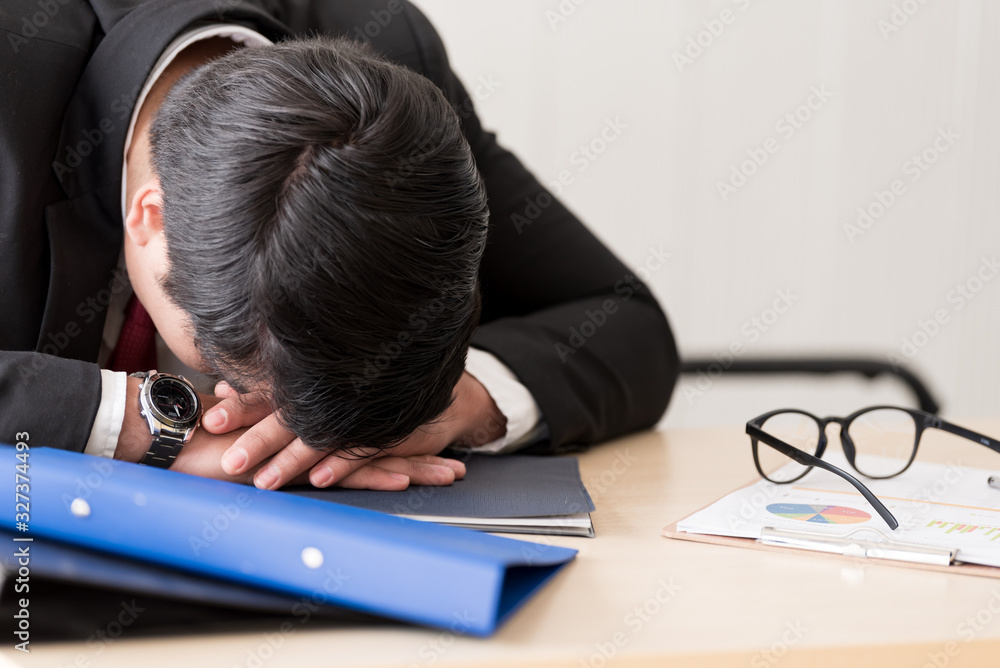 A businessman slept in the working time at the office. A businessman slept in the working time at the office.