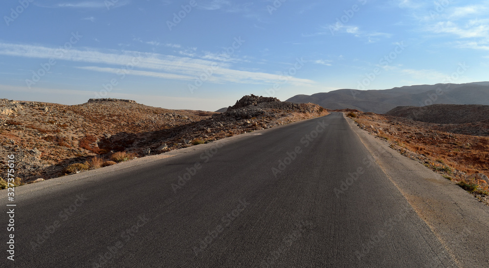 Straight road in the desertic landscape of Mount Lebanon in summer, Faraya, Lebanon