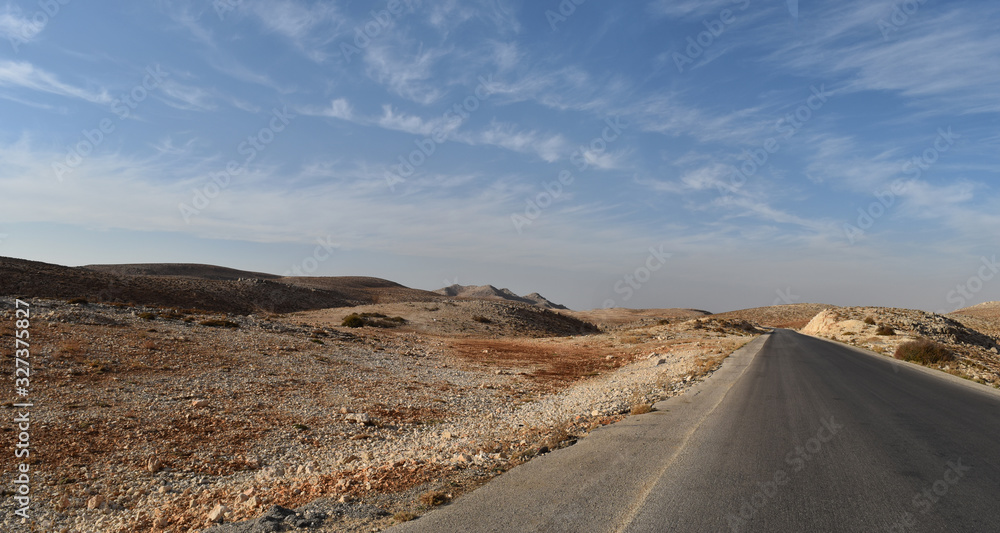 Straight road in the desertic landscape of Mount Lebanon in summer, Faraya, Lebanon