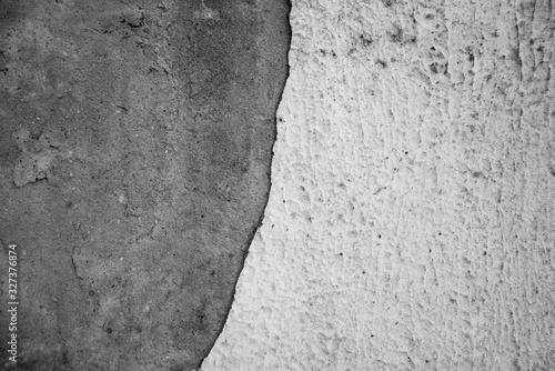 Part of the wall with the missing part of the plaster. Two halves. A state of disrepair.