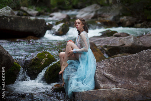 Fototapeta Naklejka Na Ścianę i Meble -  The Tale of the Mermaid. Tale of the River Nymph. Girl in a blue dress by the river.