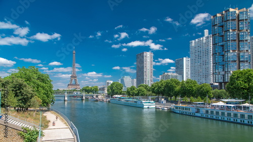 Eiffel tower at the river Seine timelapse from bridge in Paris, France photo