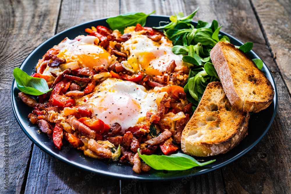 Shakshuka - fried eggs with bacon and vegetables